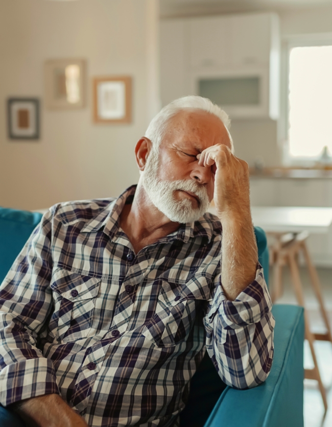 An older gentleman struggles with drowsiness.